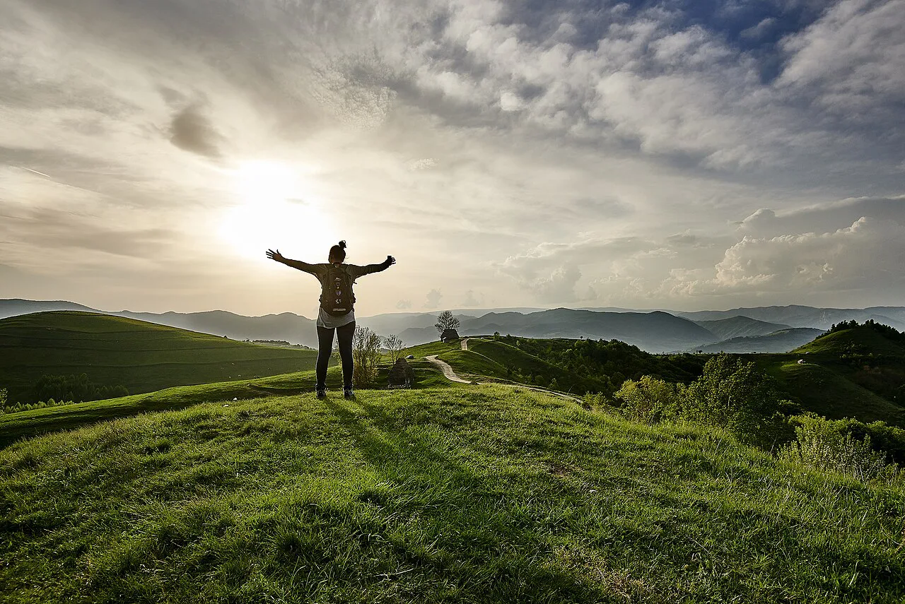 Hiker on a hilltop in the Apuseni Mountains.