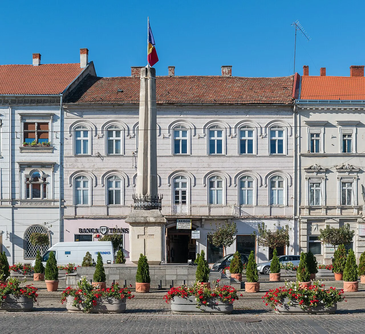 Historic building with flower beds on Bulevardul Revoluției in Arad.