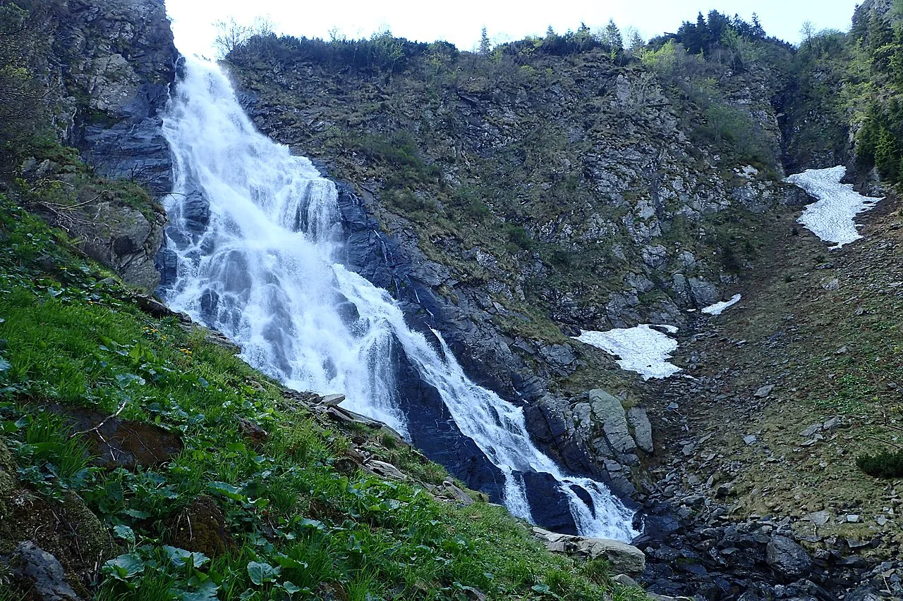 Bâlea Waterfall tumbling past late snow patches.