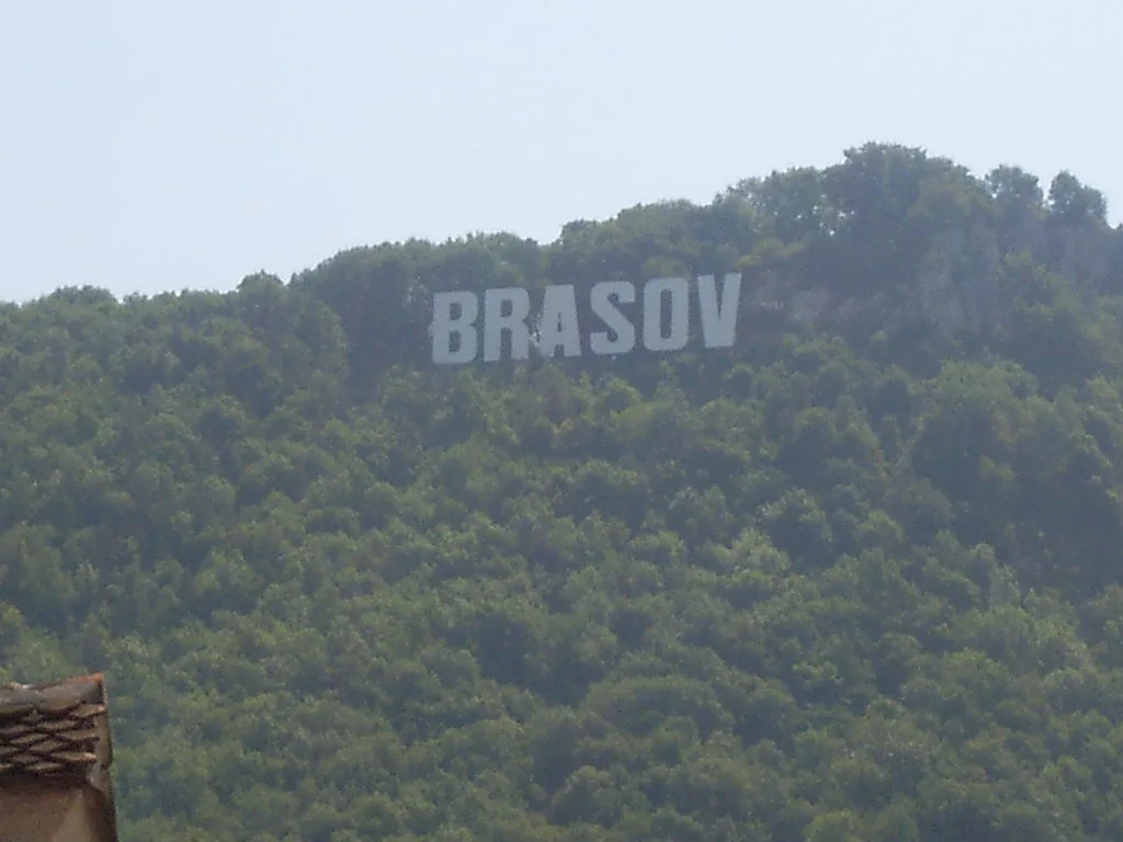 The Brașov sign on the wooded slopes of Tâmpa Mountain.