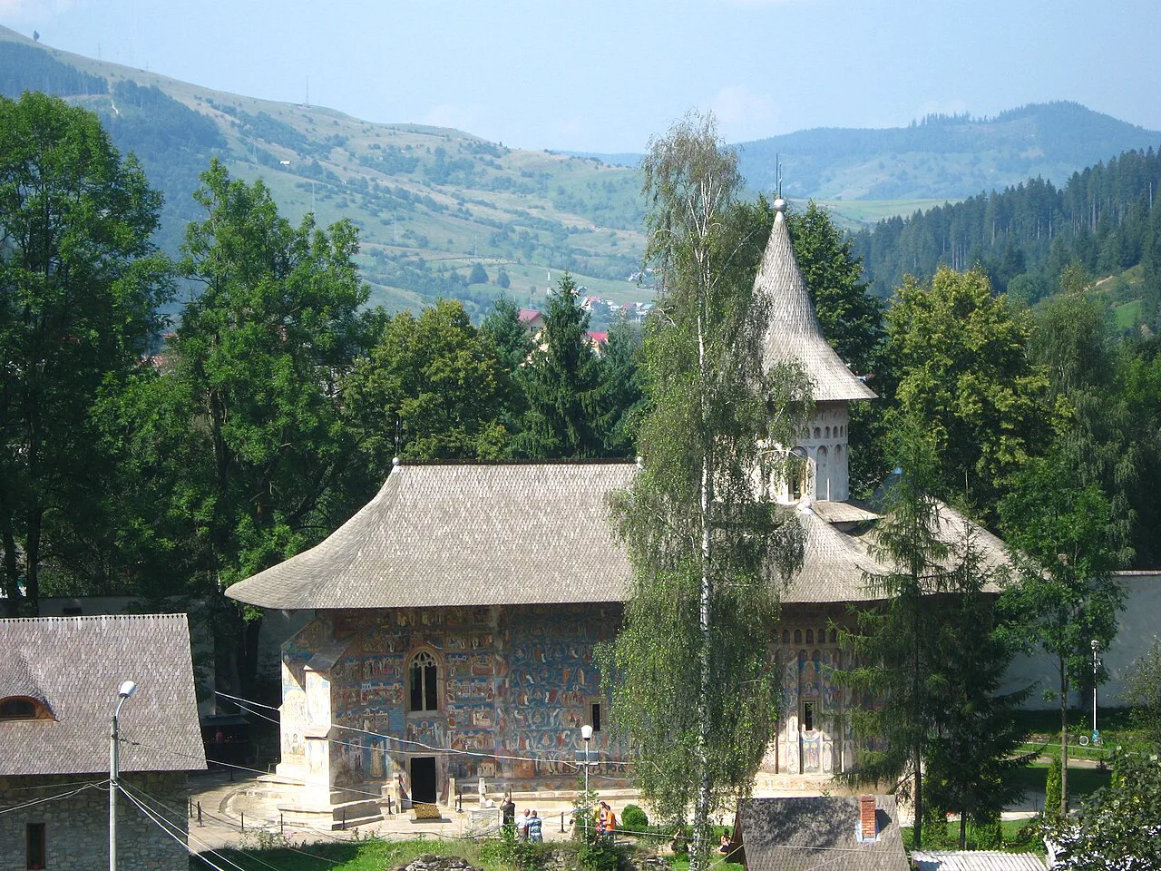 Voroneț Monastery seen from above, with the hills behind.