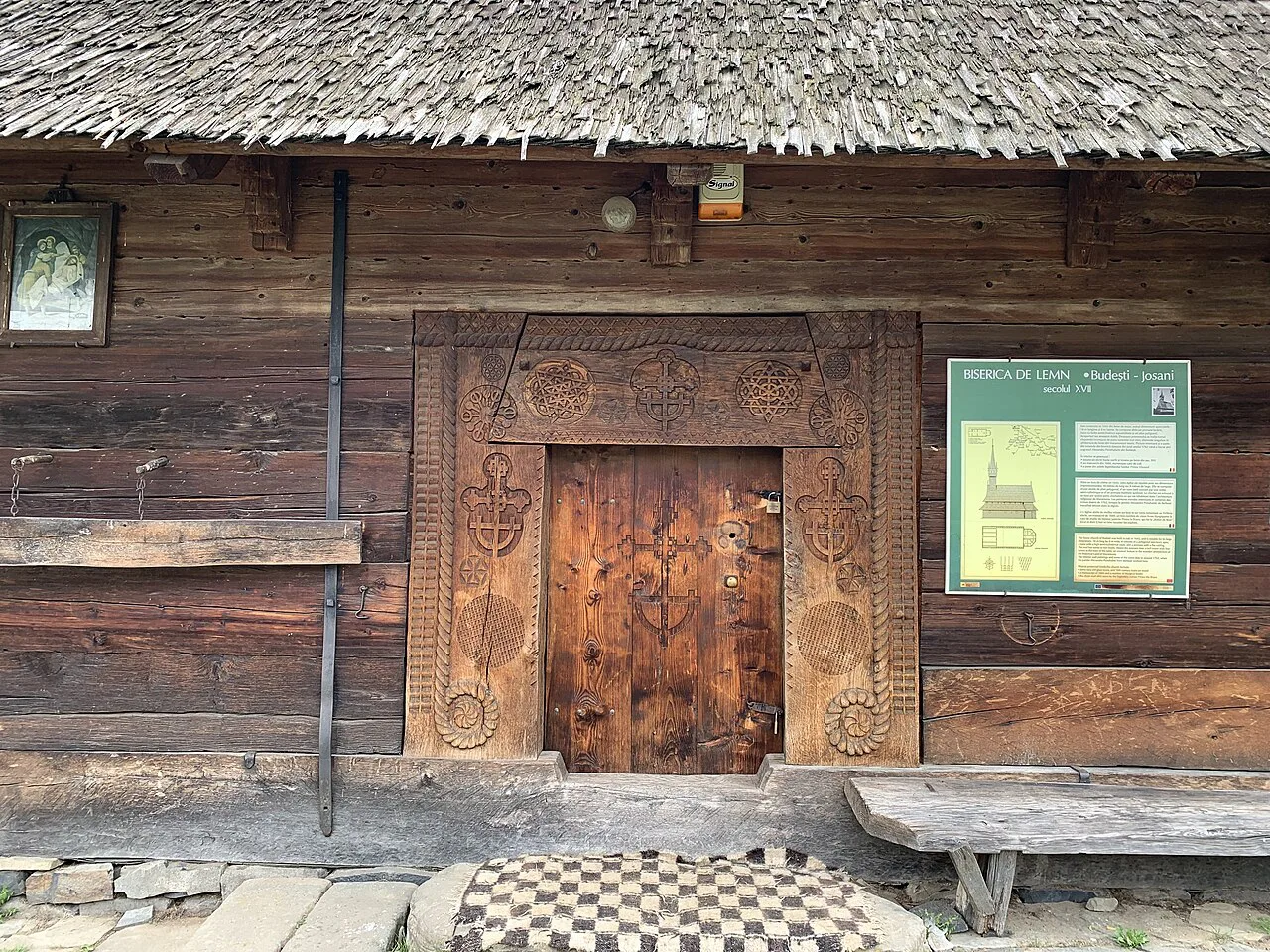 Carved doorway of the Saint Nicholas wooden church in Budești Josani.