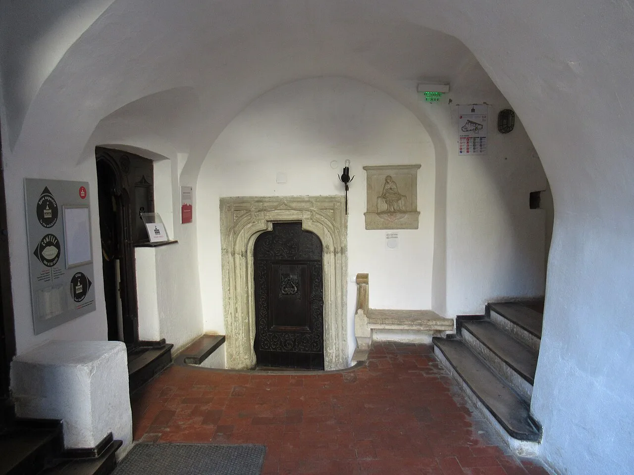 A whitewashed room with a tiled stove inside Bran Castle.