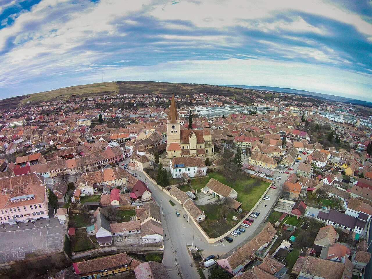 Aerial view of the fortified church and rooftops of Cisnădie.