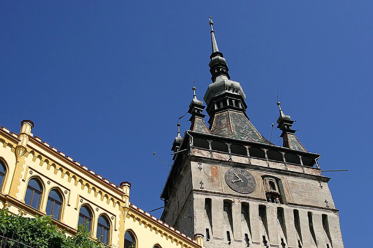 The Clock Tower in Sighișoara against a blue sky.