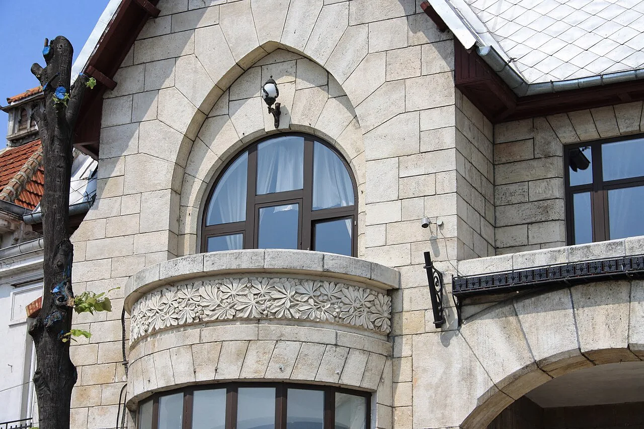 Stone façade with an arched window in Constanța's old town.