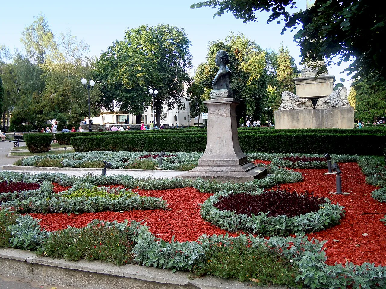 Mihai Eminescu's bust and flower beds in Copou Park, Iași.