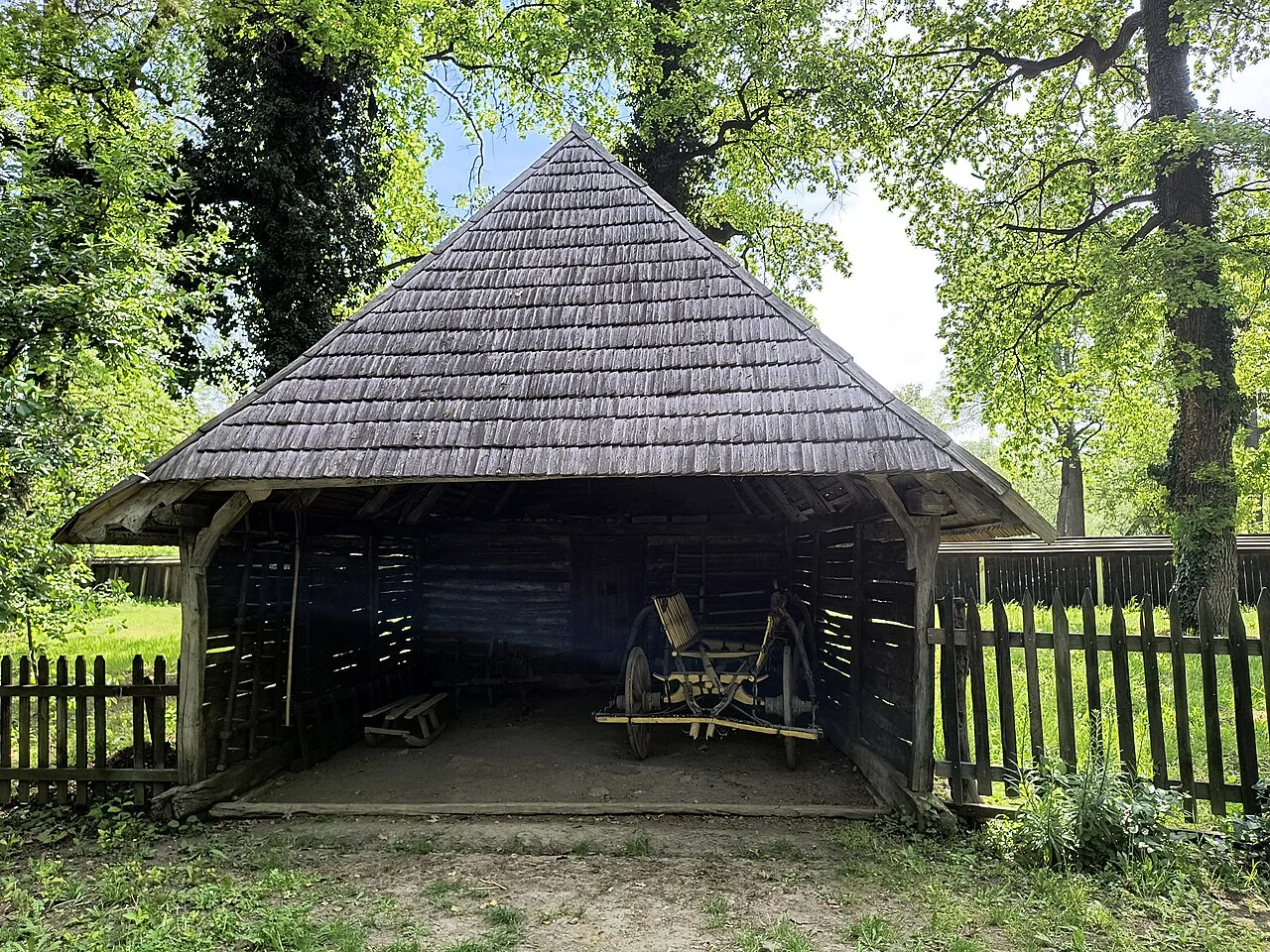 A shingled wooden shelter at the Banat Village Museum, Timișoara.