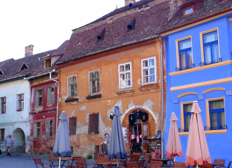 Colourful houses and café umbrellas in Sighișoara.