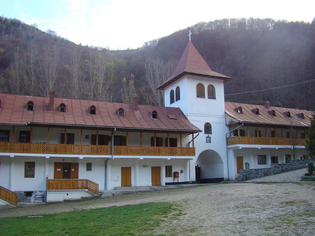 Râmeț Monastery beneath wooded hills in Alba County.