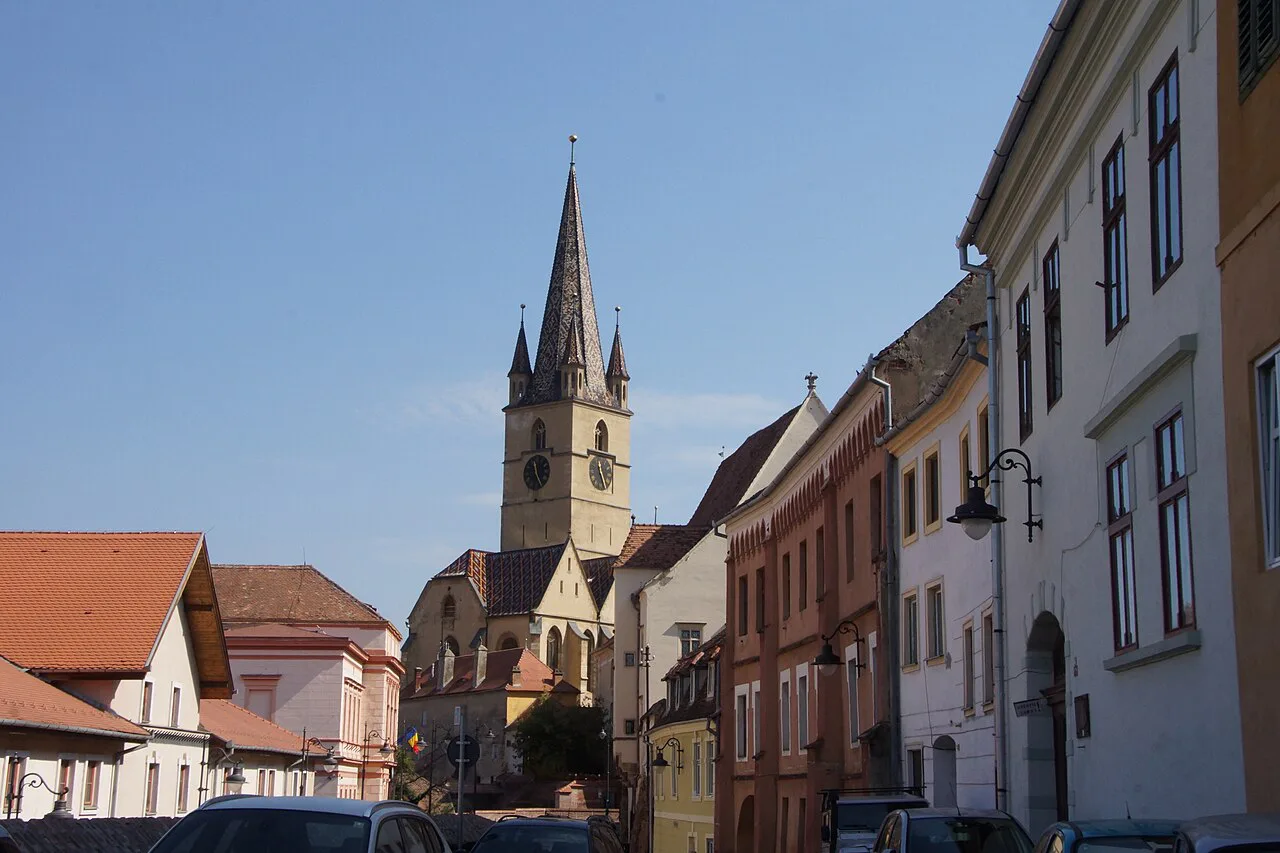 The Evangelical Cathedral spire above a street in Sibiu.