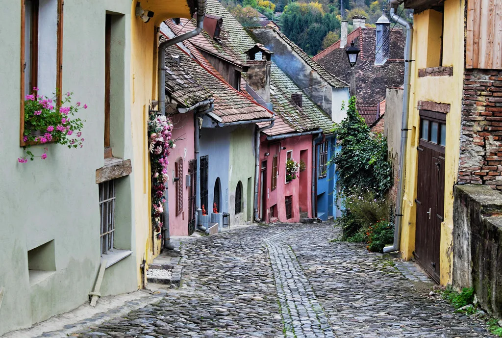 Colourful houses on a cobbled lane in Sighișoara's citadel.