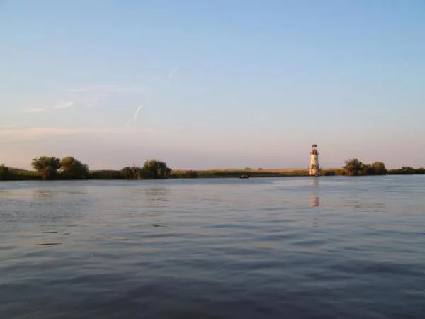 The Danube at Sulina with a lighthouse on the far bank.