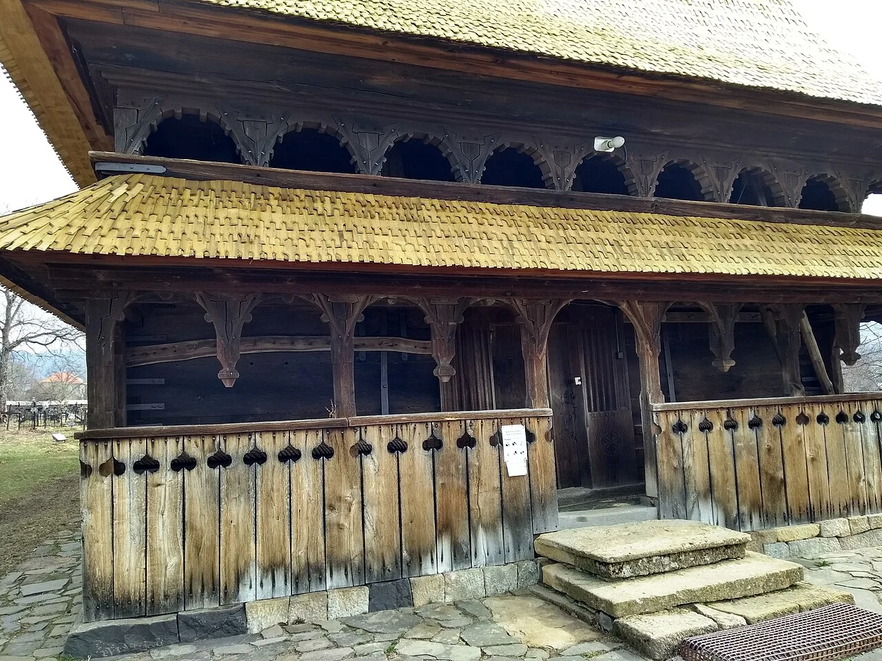 The wooden porch of the Holy Archangels Church, Șurdești.