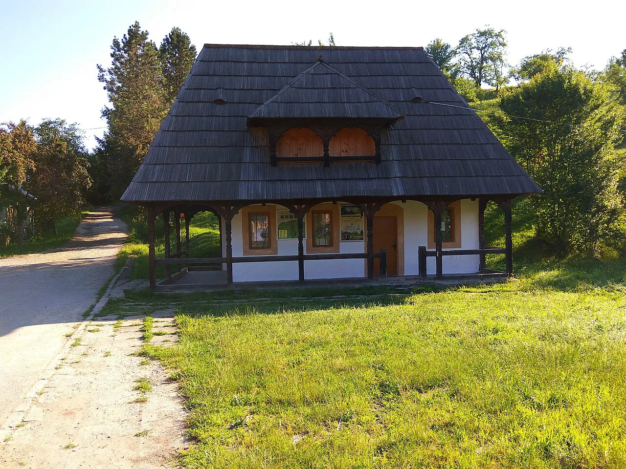 Wooden house with a shingled roof at the Maramureș Village Museum.