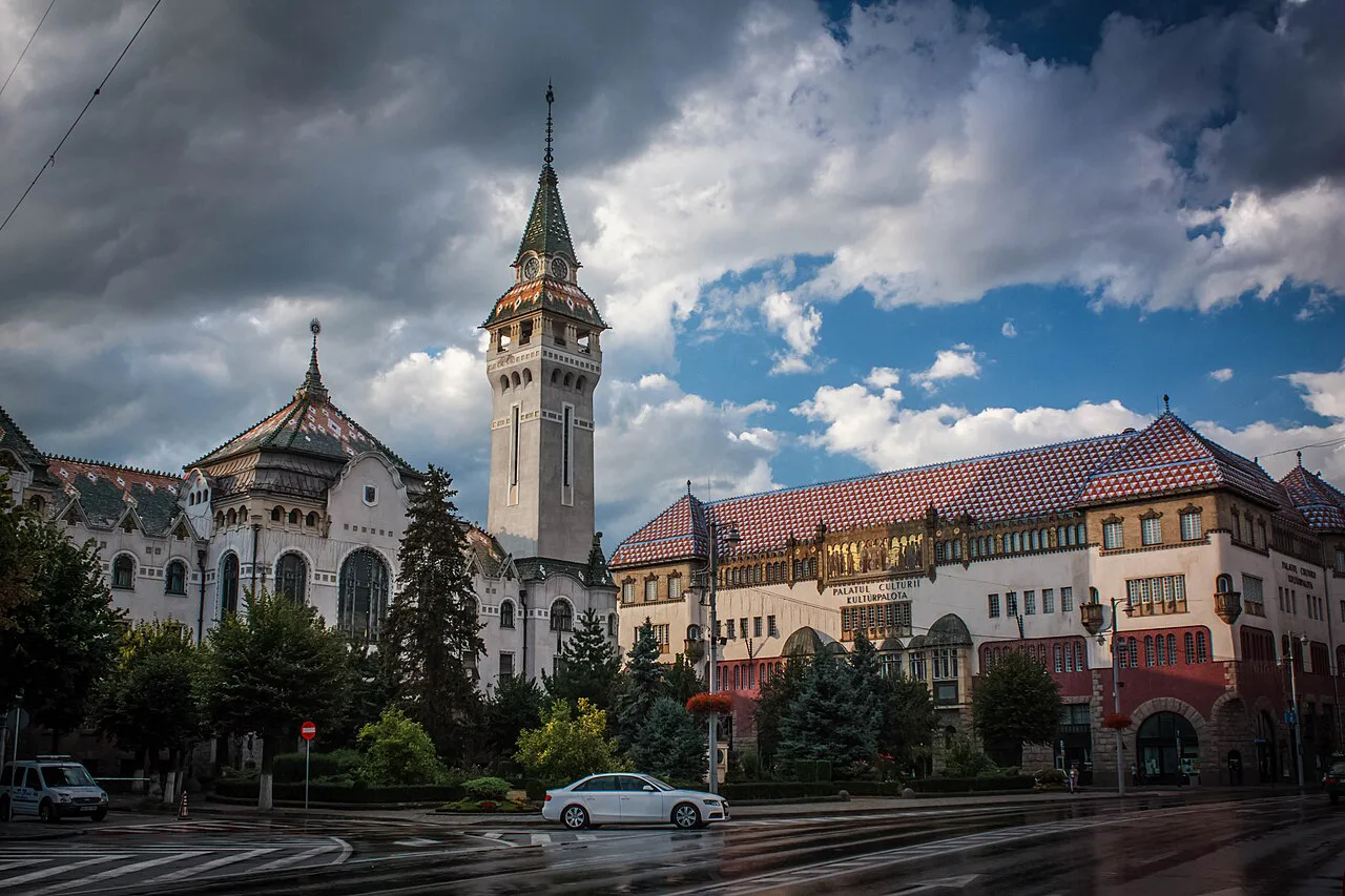 Palace of Culture in Târgu Mureș under a dramatic sky.