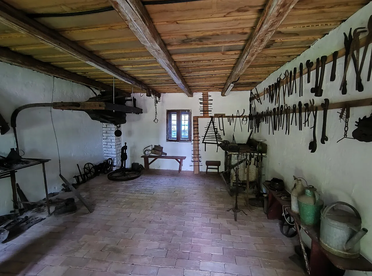 A tool-lined workshop interior at the Banat Village Museum, Timișoara.